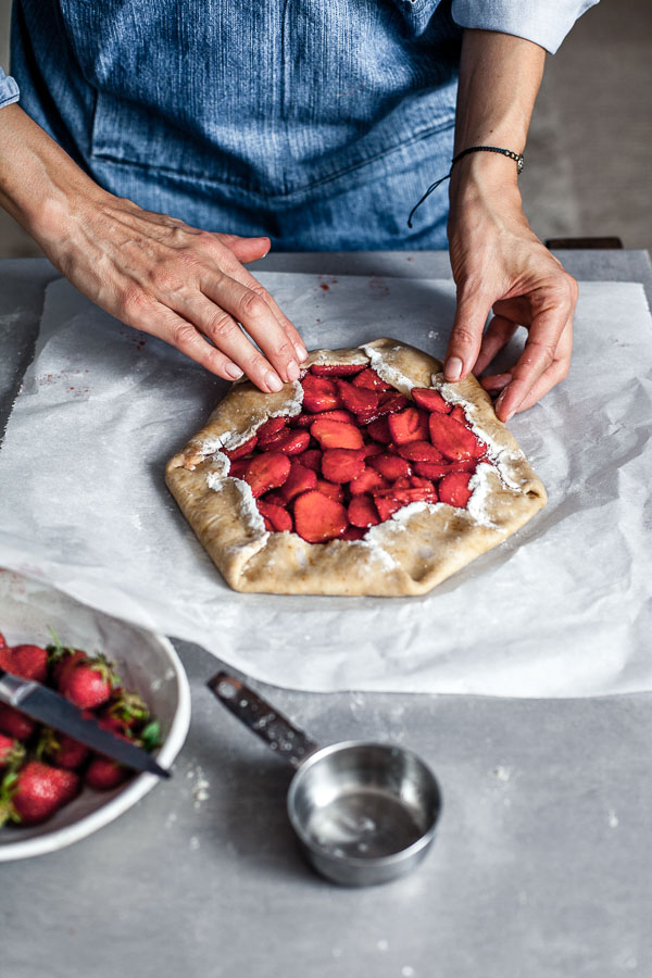 Making of strawberry galette, Puling up the edges of pastry over filling, Maja Brekalo